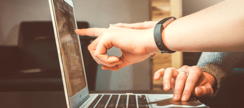 Hand pointing at a screen